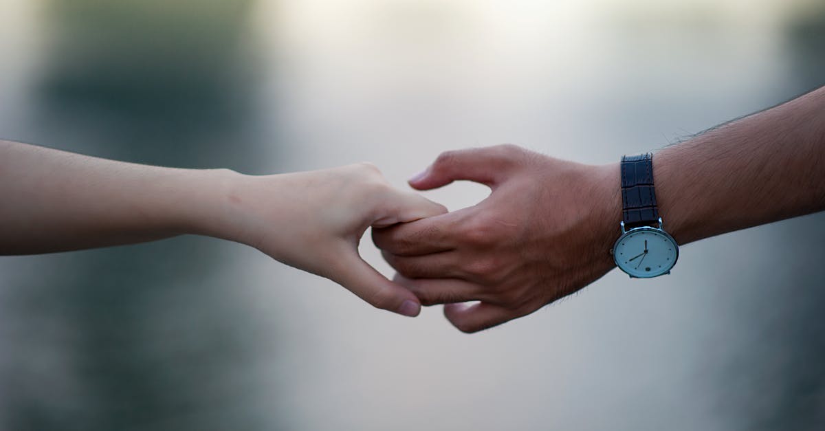 A close-up of two hands holding gently, symbolizing connection and unity.